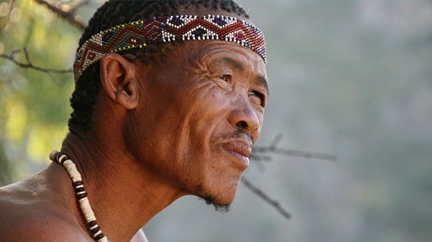 Portrait of a man with a beaded headband and necklace
