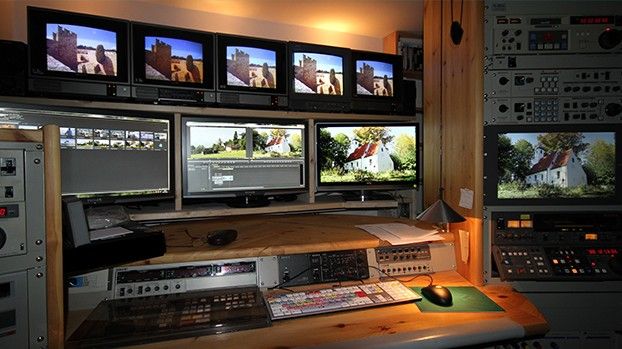 Editing suite with several monitors and video equipment