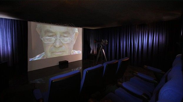 Screening room with a screen and blue cinema seats