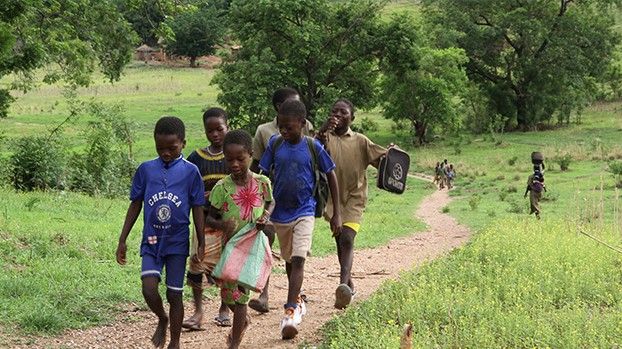 Children on a path through green countryside